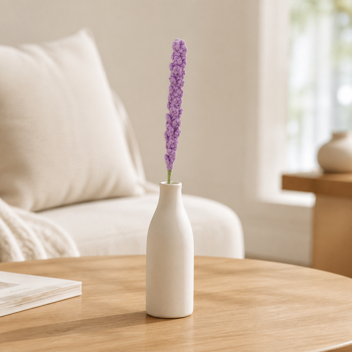 Handmade light purple crochet lavender displayed in a white vase on a coffee table