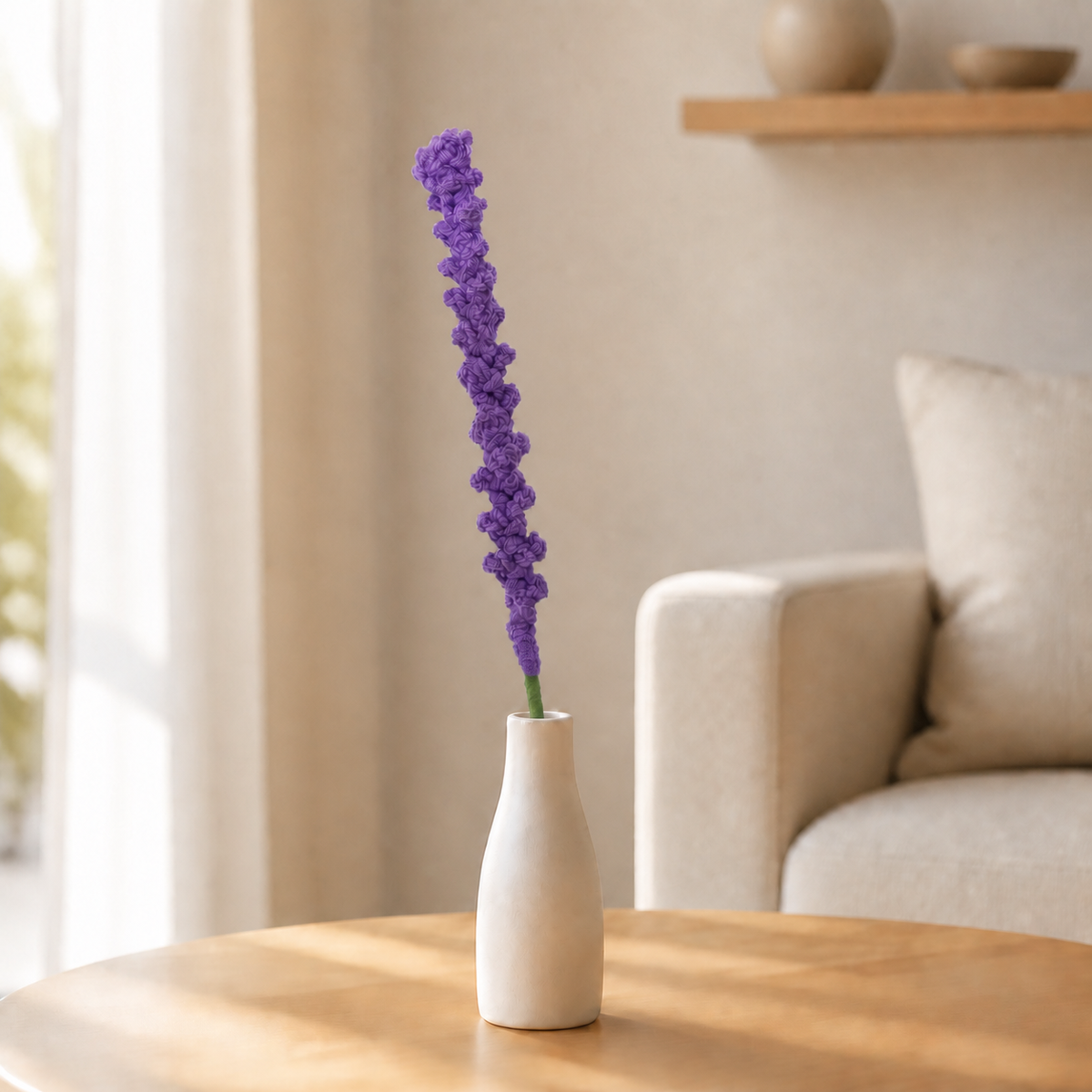 Handmade deep purple crochet lavender displayed in a white vase on a coffee table
