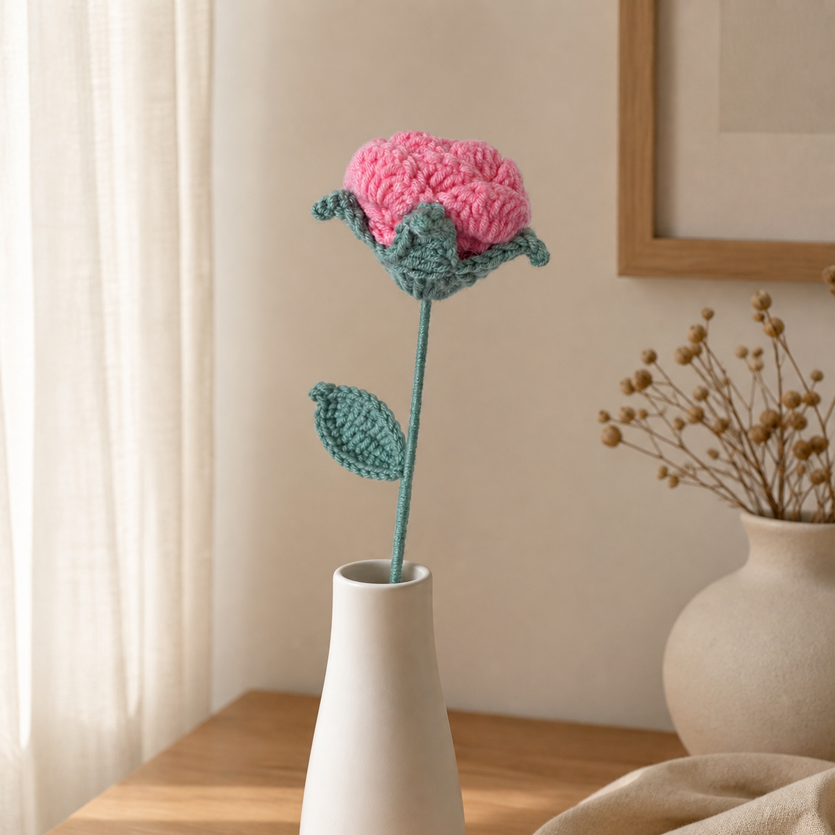 Handmade fashion pink crochet rose displayed in a slim white vase