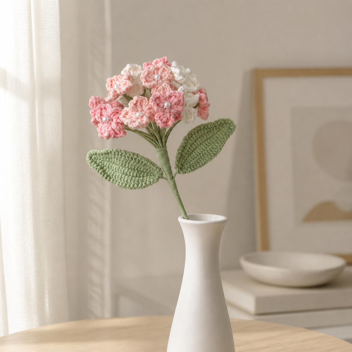 Handmade tricolor pink crochet hydrangea displayed in a slim white vase