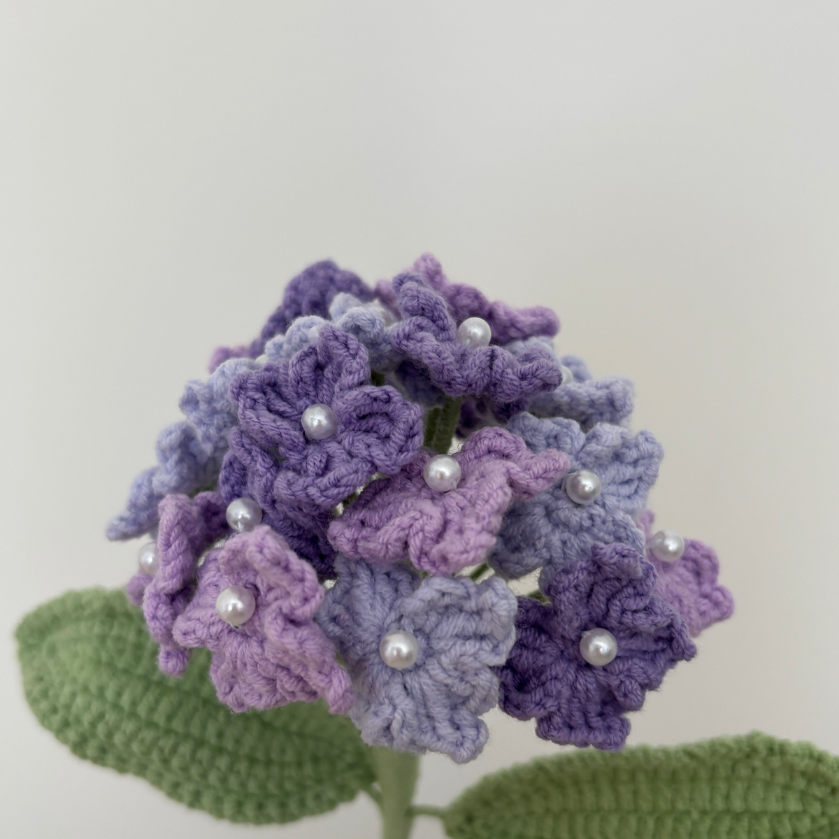 Close-up detail of tricolor purple crochet hydrangea with pearl flower centers